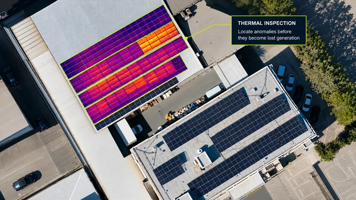 Aerial thermal inspection of a commercial rooftop solar array in Strovolos with a flagged section